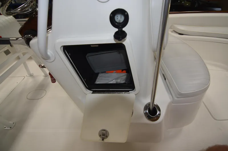 Slide: The Image of 2013 Chaos 21 Tarpon Bay boat interior with storage compartment open. - 30
