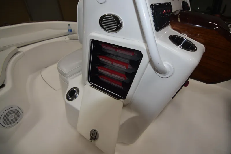 Slide: The Image of 2013 Chaos 21 Tarpon Bay boat interior with storage compartments and seating. - 32