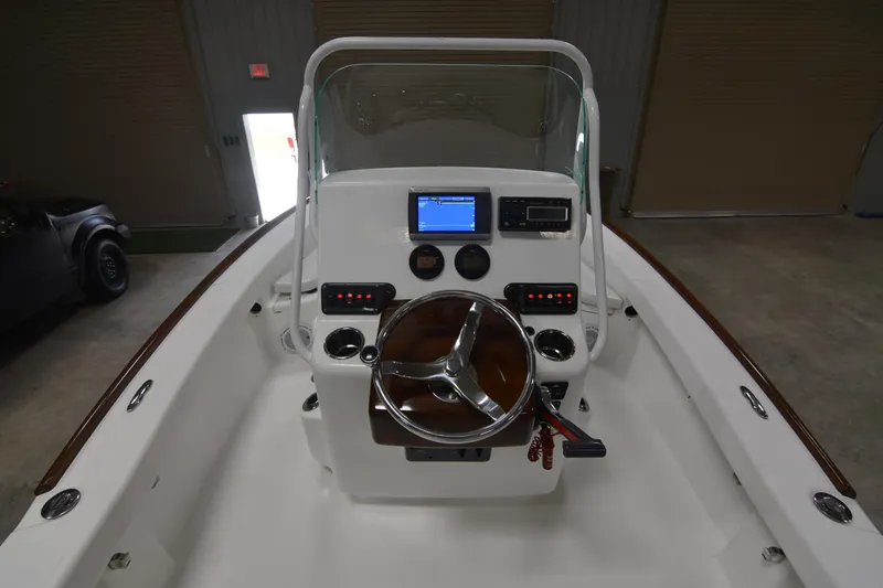 Slide: The Image of 2013 Chaos 21 Tarpon Bay boat console with steering wheel and navigation display. - 33