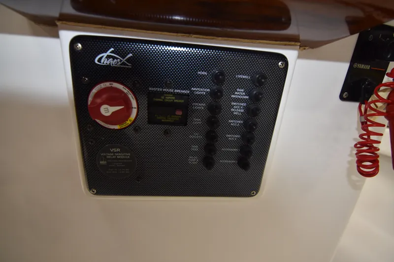 Slide: The Image of Control panel of a 2013 Chaos 21 Tarpon Bay boat with switches and a red dial. - 34