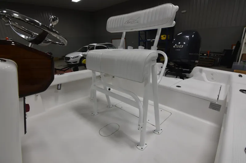 Slide: The Image of 2013 Chaos 21 Tarpon Bay boat interior with white seating and Yamaha 150 engine. - 35