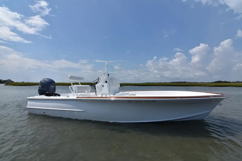 Slide: The Image of 2013 Chaos 21 Tarpon Bay boat on calm water under a partly cloudy sky. - 4
