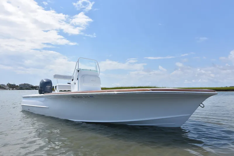 Slide: The Image of 2013 Chaos 21 Tarpon Bay boat on calm water under a clear blue sky. - 5