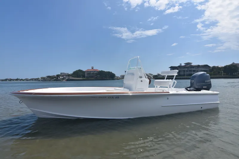 Slide: The Image of 2013 Chaos 21 Tarpon Bay boat on calm water under a clear sky. - 9