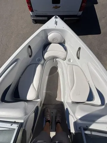 Slide: The Image of 2000 Crowline 180 BR boat interior with white seating and sleek design. - 10