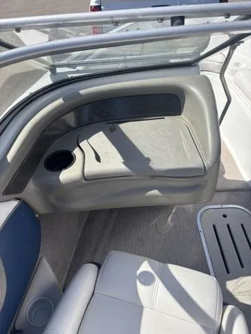 Slide: The Image of Interior of a 2000 Crowline 180 BR boat, featuring seating and cup holder. - 13