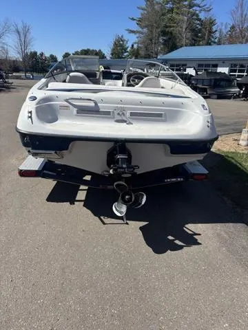 Slide: The Image of 2000 Crowline 180 BR boat, rear view, parked on pavement, sunny day. - 5