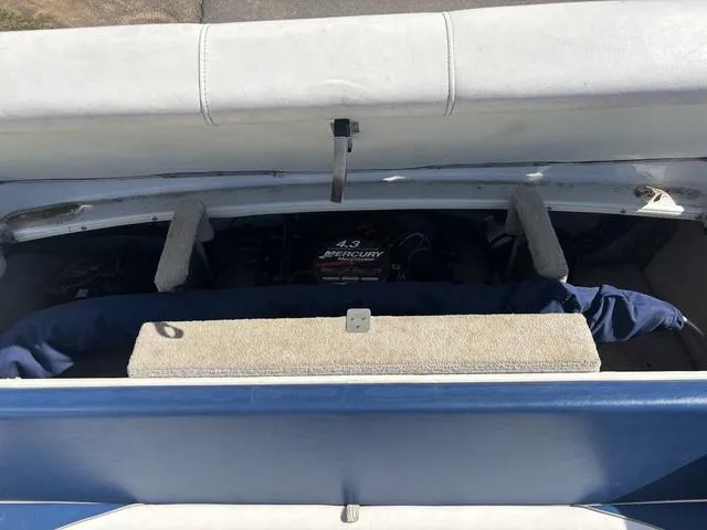 Slide: The Image of 2000 Crowline 180 BR boat engine compartment with 4.3 Mercury engine visible. - 9