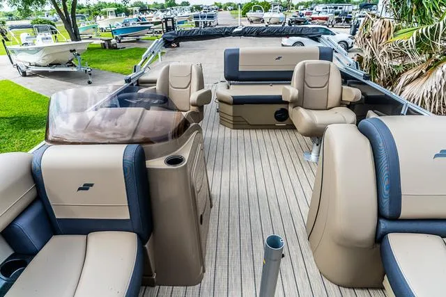 Slide: The Image of 2025 Starcraft EX20QDH pontoon boat interior with beige seating and wood-style flooring. - 11