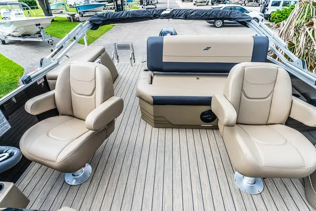 Slide: The Image of 2025 Starcraft EX20QDH boat interior with beige seating and wood-style flooring. - 12