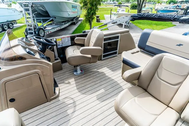 Slide: The Image of Interior of 2025 Starcraft EX20QDH boat with beige seating and modern dashboard. - 13
