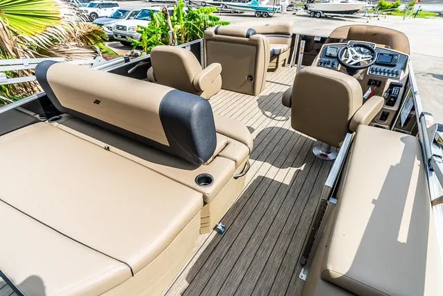 Slide: The Image of 2025 Starcraft EX20QDH pontoon boat with beige seating and modern dashboard. - 4