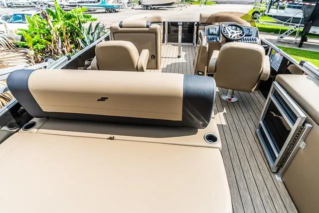 Slide: The Image of 2025 Starcraft EX20QDH boat interior with beige seating and modern dashboard. - 5