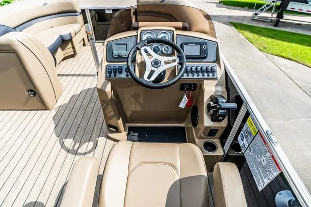 Slide: The Image of 2025 Starcraft EX20QDH boat cockpit with modern controls and steering wheel. - 6