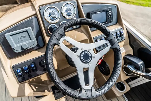 Slide: The Image of Steering console of 2025 Starcraft EX20QDH boat with modern controls and gauges. - 7