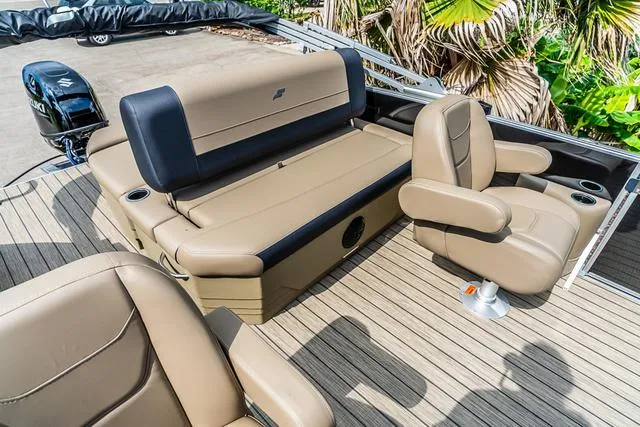 Slide: The Image of 2025 Starcraft EX20QDH boat interior with tan seating and wood deck. - 9