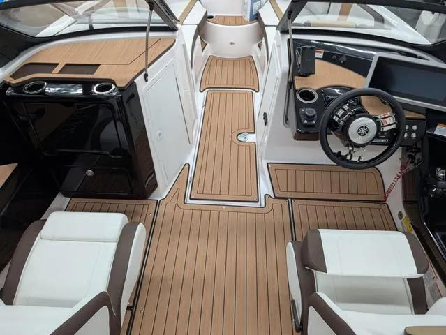 Slide: The Image of 2023 Yamaha Boats 222SD interior with sleek design, wood accents, and modern controls. - 4