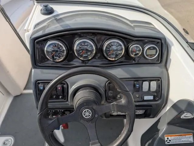 Slide: The Image of 2009 Yamaha Boats SX 230 dashboard with gauges and steering wheel. - 10