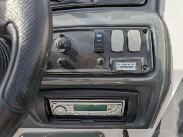 Slide: The Image of Dashboard of 2009 Yamaha SX 230 boat with controls and stereo system. - 12