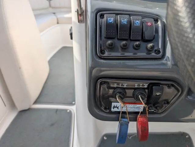 Slide: The Image of Control panel of 2009 Yamaha Boats SX 230 with switches and key slots. - 13