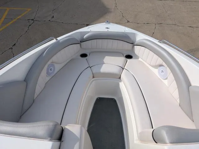 Slide: The Image of 2009 Yamaha Boats SX 230 interior with white cushioned seating and speakers. - 14