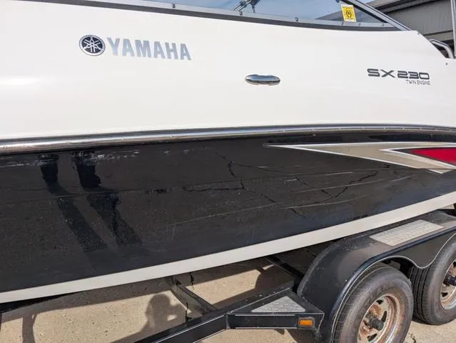Slide: The Image of 2009 Yamaha SX 230 boat on trailer, side view showing logo and sleek design. - 6