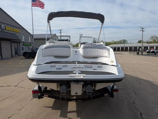 Slide: The Image of 2009 Yamaha Boats SX 230 in parking lot, rear view with American flag in background. - 7