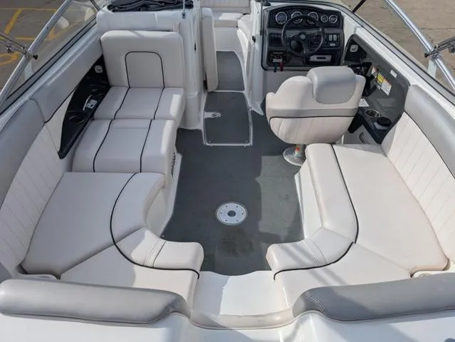 Slide: The Image of 2009 Yamaha Boats SX 230 interior with white seating and steering console. - 9