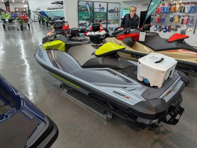 Slide: The Image of 2024 Sea-Doo RXP-X 325 Ibr in Ice Metal/Green on showroom floor. - 7