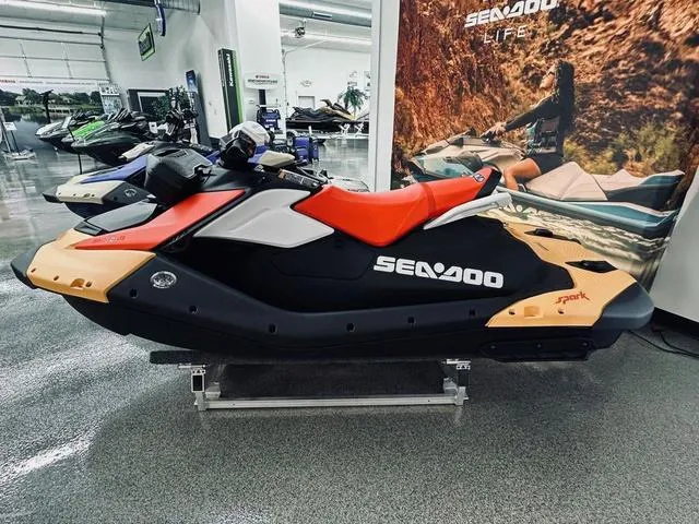 Slide: The Image of 2024 Sea-Doo Spark Waverunner on display in showroom, featuring sleek design and vibrant colors. - 4