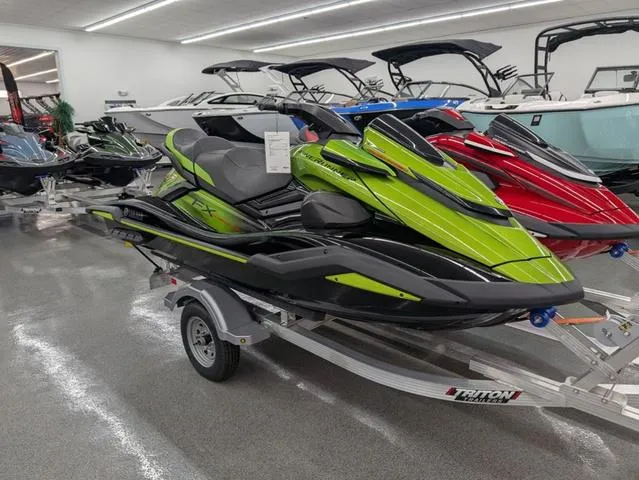 Slide: The Image of 2024 Yamaha WaveRunner FX Cruiser SVHO in showroom, vibrant green and black design on trailer. - 1