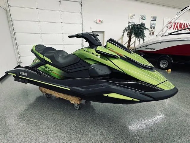 Slide: The Image of 2024 Yamaha WaveRunner FX Cruiser SVHO in a showroom, vibrant green and black design. - 2