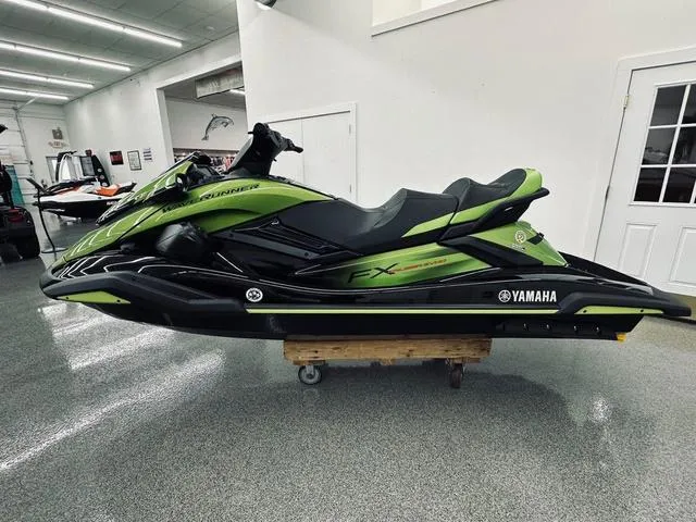 Slide: The Image of 2024 Yamaha WaveRunner FX Cruiser SVHO in a showroom, green and black design. - 4