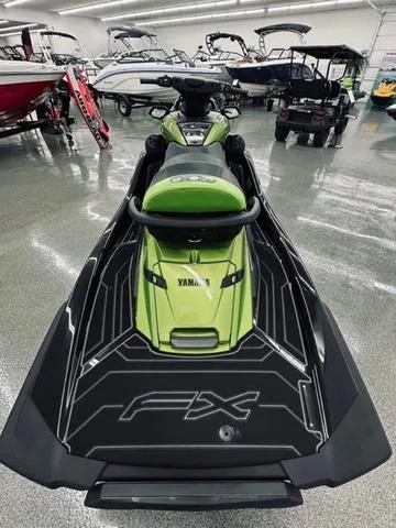 Slide: The Image of 2024 Yamaha WaveRunner FX Cruiser SVHO in showroom, green and black design. - 5