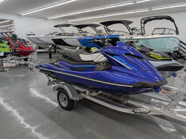 Slide: The Image of 2024 Yamaha WaveRunner GP SVHO with Audio, blue, displayed in a showroom on a trailer. - 1