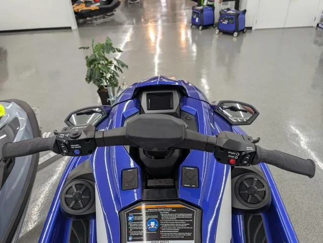 Slide: The Image of 2024 Yamaha WaveRunner GP SVHO with Audio, blue dashboard and handlebars, indoor showroom. - 4