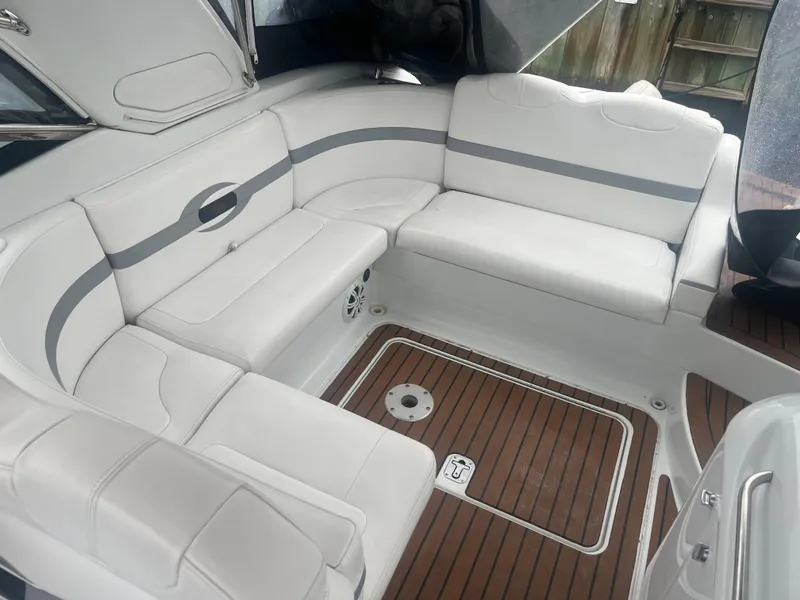 Slide: The Image of 2008 Formula 310 Bowrider interior with white seating and teak flooring. - 14