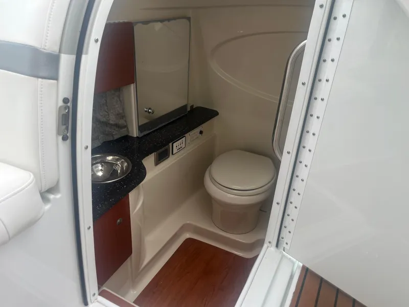 Slide: The Image of 2008 Formula 310 Bowrider interior bathroom with sink, toilet, and mirror. - 15