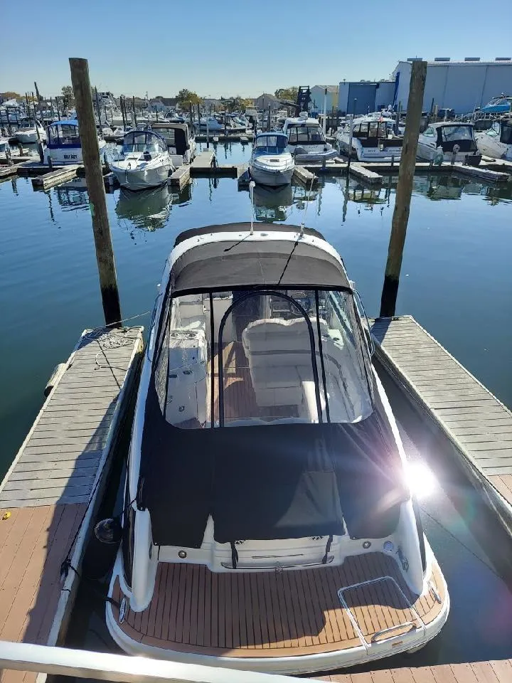 Slide: The Image of 2008 Formula 310 Bowrider docked at a marina with other boats. - 6