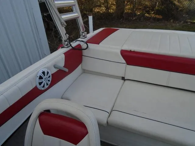 Slide: The Image of 2013 Bayliner 185 Bowrider interior with red and white seating and speaker. - 15