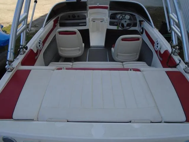 Slide: The Image of 2013 Bayliner 185 Bowrider interior with red and white seating and steering wheel. - 24