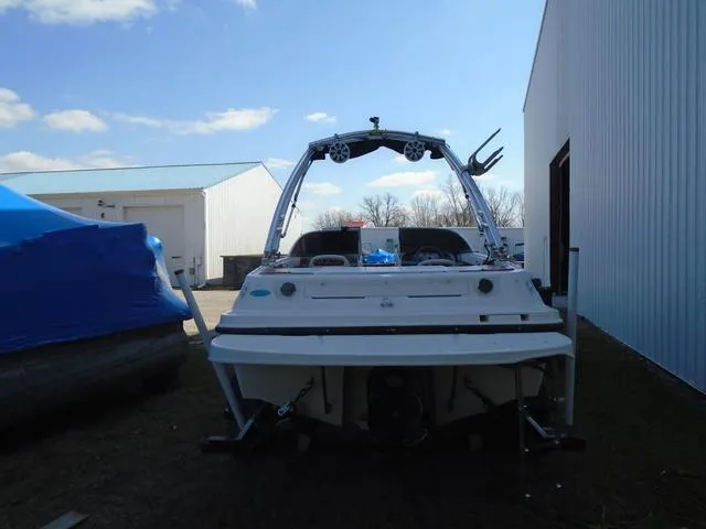 Slide: The Image of 2013 Bayliner 185 Bowrider boat, rear view, parked outdoors near buildings. - 26