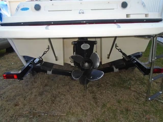 Slide: The Image of 2013 Bayliner 185 Bowrider boat stern with propeller and ladder on grass. - 27