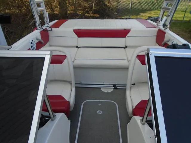 Slide: The Image of 2013 Bayliner 185 Bowrider interior with red and white seating, open deck layout. - 3