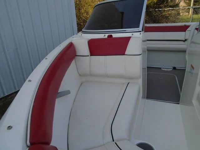 Slide: The Image of 2013 Bayliner 185 Bowrider interior with red and white seating, showcasing spacious design. - 33