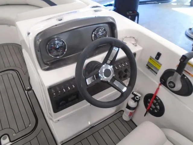 Slide: The Image of 2023 Hurricane SunDeck Sport 188 IO boat dashboard with steering wheel and controls. - 10