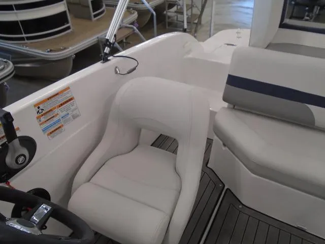 Slide: The Image of 2023 Hurricane SunDeck Sport 188 IO boat interior with white seating and steering wheel. - 11