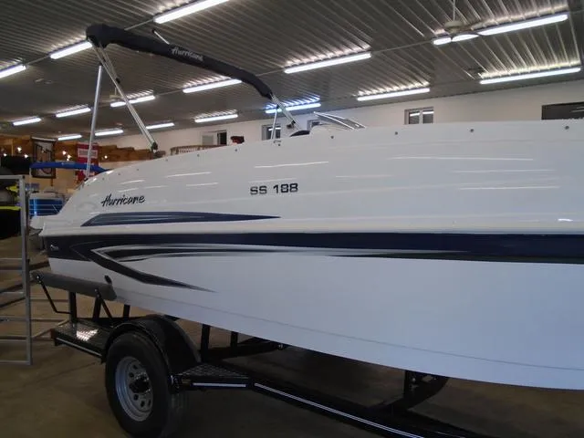 Slide: The Image of 2023 Hurricane SunDeck Sport 188 IO boat in showroom, side view on trailer. - 18