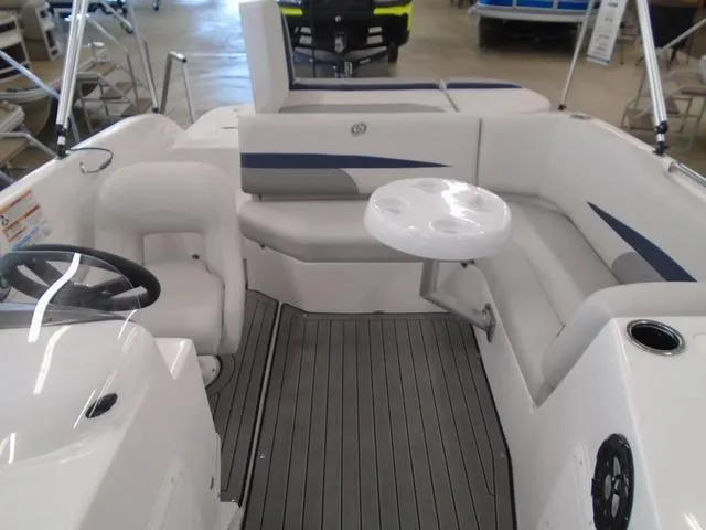 Slide: The Image of 2023 Hurricane SunDeck Sport 188 IO boat interior with seating and table. - 8