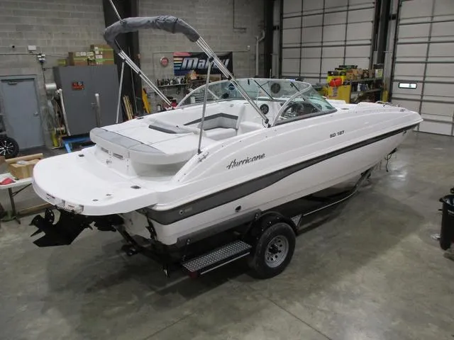 Slide: The Image of 2023 Hurricane SunDeck 187 IO boat in a garage, on a trailer, ready for transport. - 3